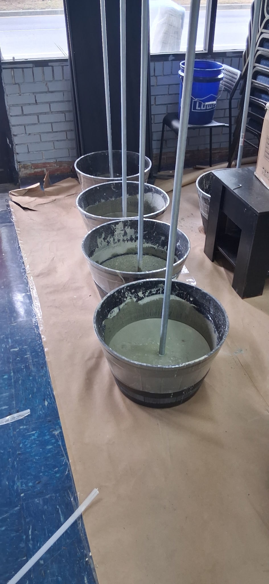 Concrete buckets with poles during pantry setup