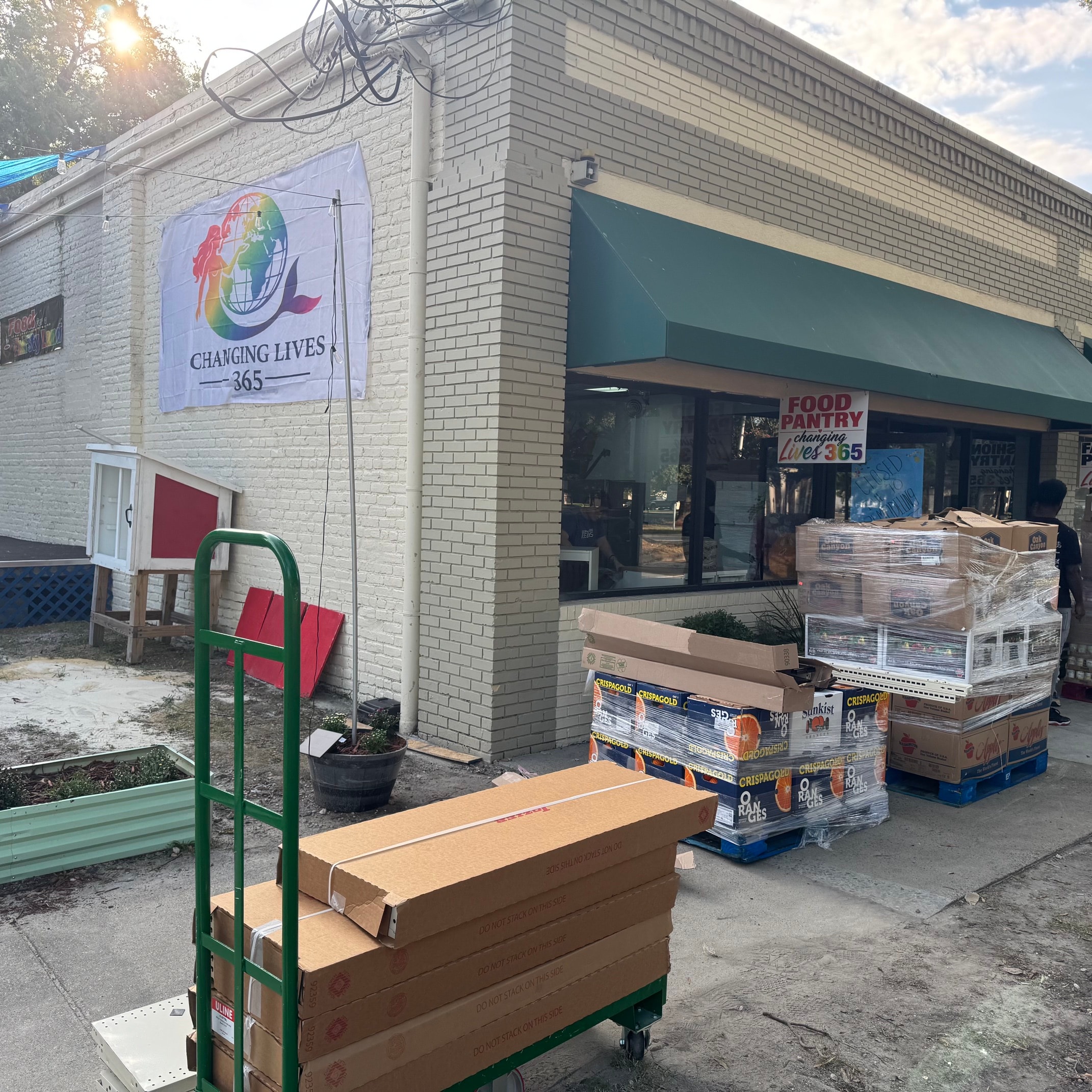 Food Pantry delivery day with supplies outside storefront